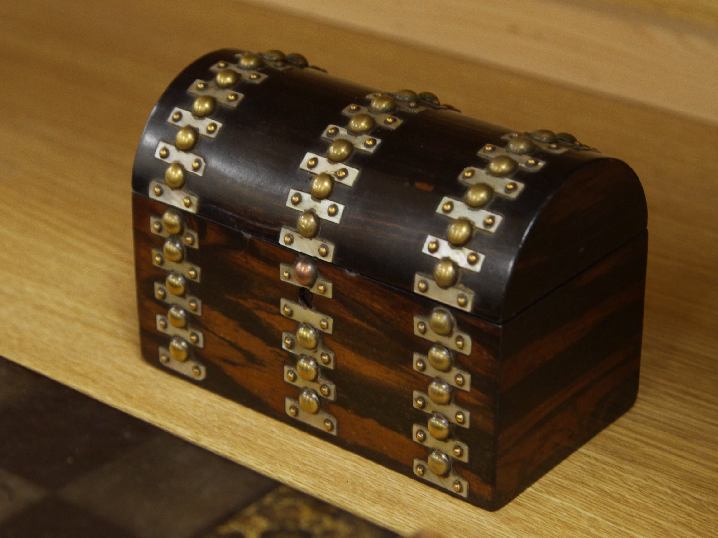 A late 19th/early 20th century Chinese lacquer chess board/box and a brass and mother of pearl mounted coromandel dome topped caddy, largest 49cm. Condition - fair